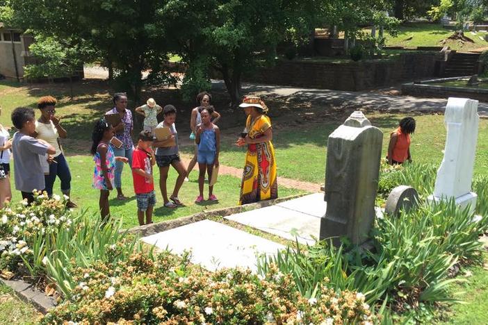 Genealogist and historian D. L. Henderson leads a tour of African American gravesites at Oakland Cemetery in Atlanta on June 11, 2016.