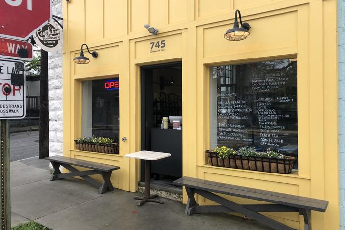 Businesses in Atlanta, as well as across Georgia and much of the United States, are trying to adapt to the public health crisis. A donut shop near Inman Park keeps customers at the front door, and offers hand sanitizer with their selection of pastry.