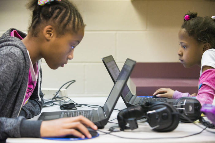 Victoria Homer, left, and Kayla Holston work on cartoons of their own design using blocks of computer code during a STEM focused class at Northside Elementary School in Warner Robins.