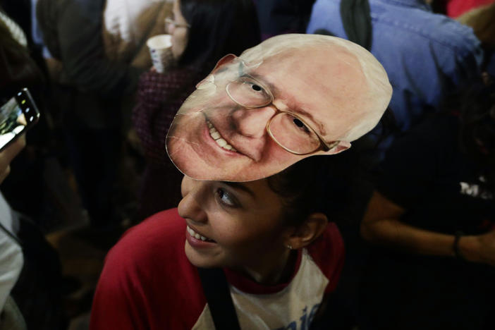 Michelle Nicoleq wears a Bernie Sanders mask as she attends a campaign event for Democratic presidential candidate Sen. Bernie Sanders, I-Vt., in San Antonio, Saturday, Feb. 22, 2020.