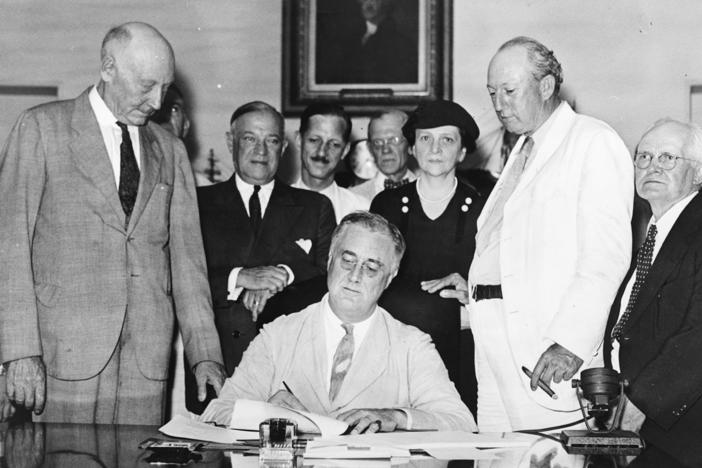 President Franklin D. Roosevelt signs the Social Security Act into law on August 14, 1935.