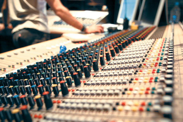 A mixing console inside a recording studio