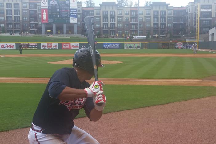 Matt Tuiasosopo warms up before his plate appearance against the Buffalo Bisons