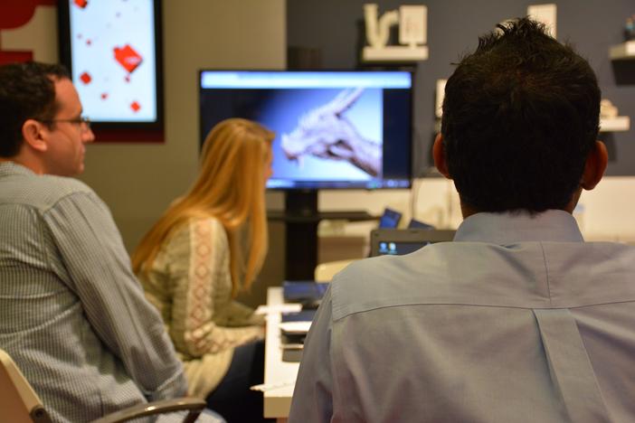 Students engrossed in a demonstration of the power of 3-D modeling and printing at the Museum of Design Atlanta.