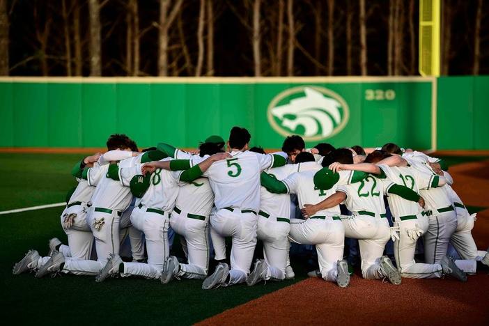 The Buford highschool baseball team huddles together before a game