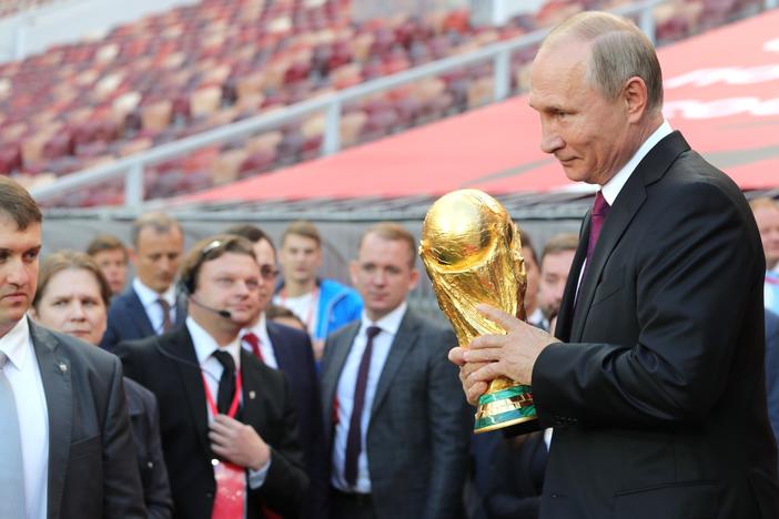 Russian president Vladimir Putin holding the FIFA World Cup Trophy at a pre-tournament ceremony in Moscow, September 2017