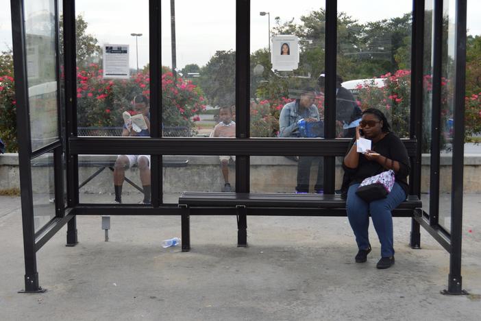 Yvette MacPherson and other commuters waiting for their Gwinnett County Transit (GCT) bus.