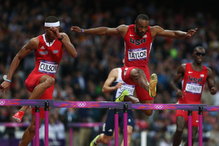 Angelo Taylor (center) leap over a hurdle in the Men's 400m Hurdles final of the London 2012 Olympic Games at the Olympic Stadium.