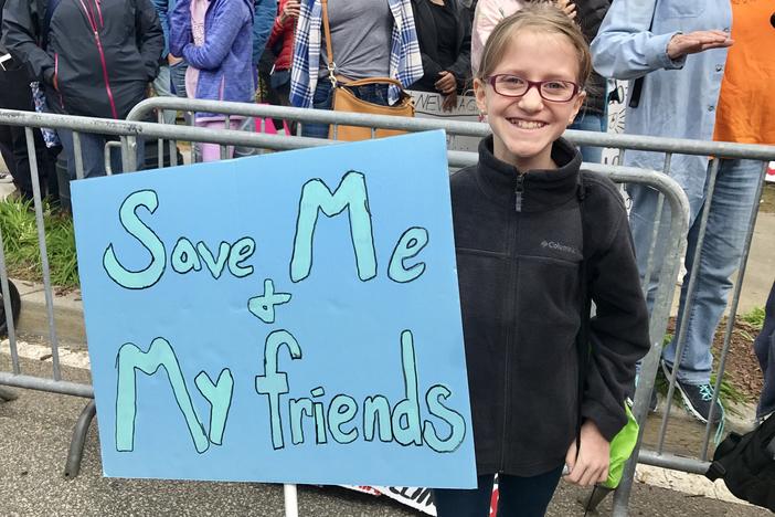 11-year-old Anneleise Dunn proudly holds the sign she carried at the March For Our Lives Rally on Saturday, March 24, 2018, in Atlanta.