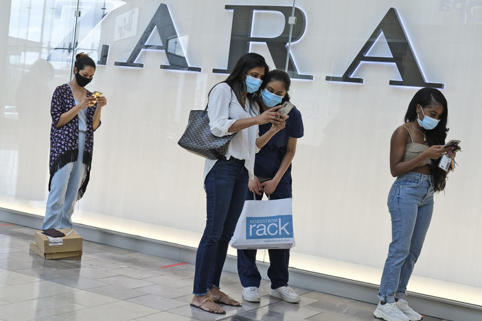 Customers wait in line to enter a Zara store inside the newly reopened Garden State Plaza mall in Paramus, N.J., on June 29.