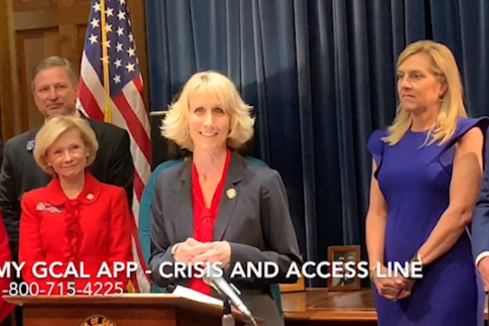 Judy Fitzgerald speaks Thursday, Feb. 14, during Gov. Brian Kemp's press conference about the Georgia Crisis and Access Line app.