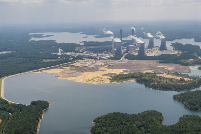 Georgia Power's Plant Scherer with the coal ash pond, foreground, where residuals from burning coal at the plant are stored. The pond goes to depths of 80 feet in some places and comes into contact with groundwater. 