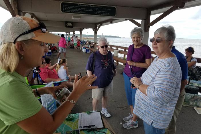 Lea King-Badyna explains to passersby why her group, Keep Golden Isles Beautiful, wants to keep cigarette butts off the beach. She's also handing out portable ashtrays.