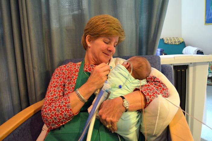 Diane Saville comforts an infant as part of the Baby Buddies program at Children's Healthcare of Atlanta at Egleston.