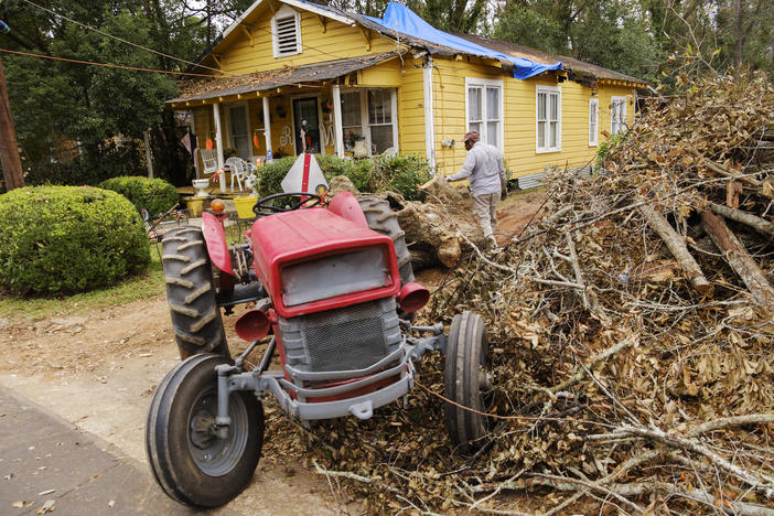 Bobby Washington his tractor to drag a piece of oak tree downed by Hurricane Michael out of a neighbor's yard in Bainbridge in October. Decatur County was one of the hardest hit areas of the state during the storm. 