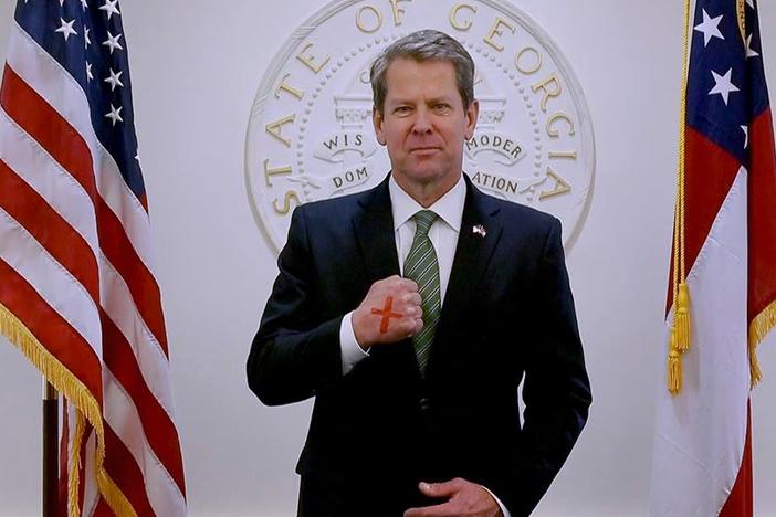 Gov. Brian Kemp poses with a red X on his hand to raise awareness for the "End It Movement" aimed at combating sex trafficking.