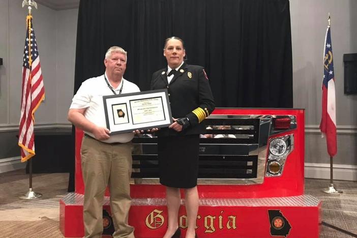 Byron Fire Chief Rachel Mosby receives the Georgia Fire Chief Certification through the Georgia Association of Fire Chiefs from Charles Wasdin at the Georgia Association of Fire Chiefs conference in April.