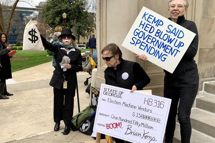 A group of protestors opposing a law overhauling the states voting system demostrate on the steps of the Georgia State Capitol. 