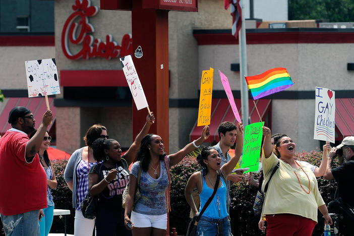 Gay rights groups and others protest and hold a "kiss-in" outside the Decatur, Ga., Chick-fil-A restaurant Friday, Aug. 3, 2012 as a public response to a company official who was quoted as supporting the traditional family unit. 