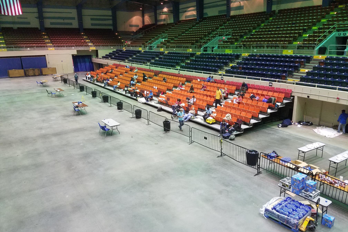 People sleep in the bleachers at the Savannah Civic Center during Hurricane Dorian.