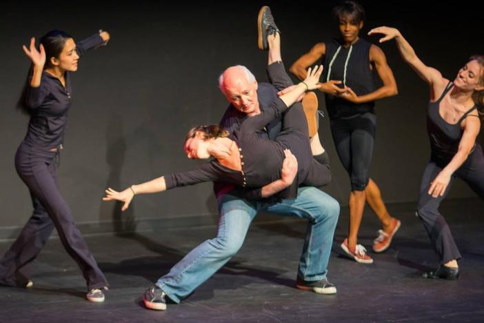 Colin Mochrie performs with dancers at Dad's Garage.