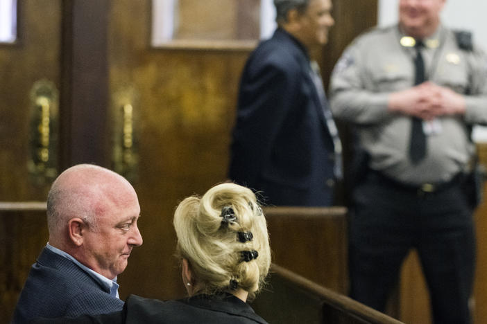 Steve Firestone, left, owner of Crystal Lake Holdings LLC, waits for the start of his hearing in Bibb County Municipal Court Friday. Firestone's attorneys convinced the court to bind Firestone's case over to state court.