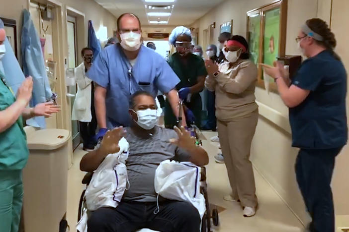 A COVID-19 patient is released to cheers from staff at Phoebe Putney Memorial Hospital in Albany last week. 