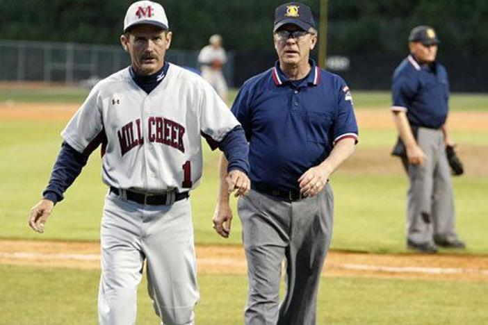 Mill Creek Head Baseball Coach Doug Jones advises players duringa game.