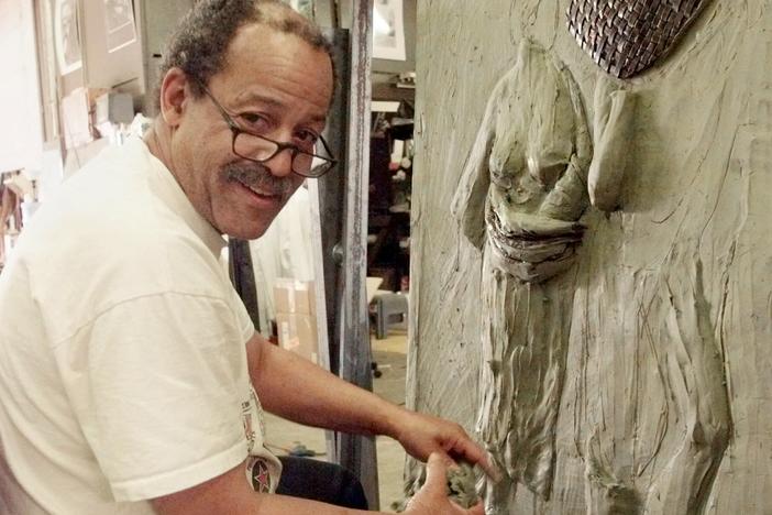 Sculptor Ed Dwight works on the third panel of a twelve panel piece in his studio in Denver, Colo., on Aug. 5, 1999.