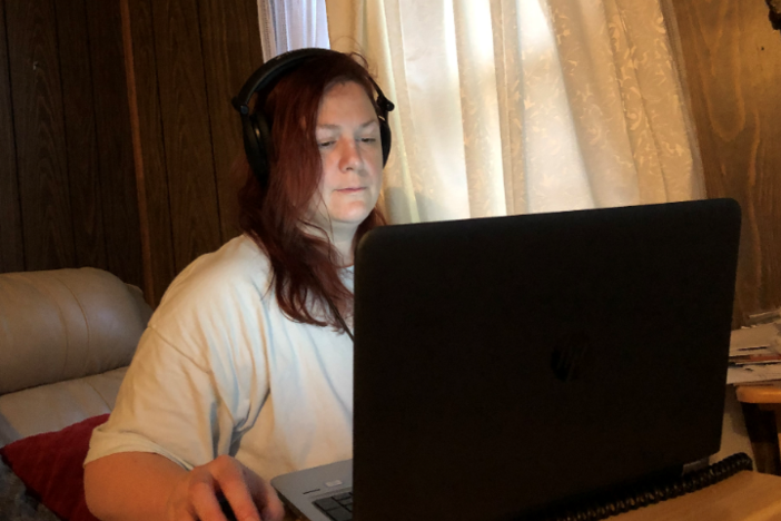 GPB News Digital Manager Ellen Eldridge listens to President Donald Trump with headphones on while working from home Friday, March 13, 2020.