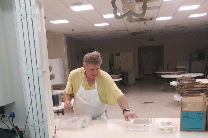 Emmaus House Clinic Supervisor Wayne Harden packages meals in to-go containers. The soup kitchen is serving meals to-go instead of in their dining hall to help stop the spread of coronavirus.