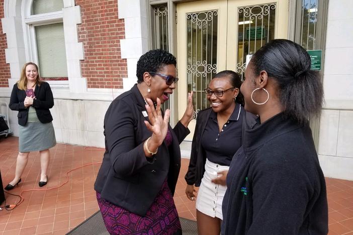 Savannah-Chatham Schools Superintendent Ann Levett talks with Savannah Arts Academy seniors Rishe Williams (center) and A'lani Coppock after announcing the district's partnerhsip to encourage FAFSA completion.