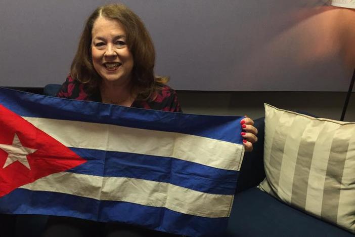 Carmen Bernal holds up the Cuban flag that her mother put on display outside their house the day Fidel Castro rose to power in 1959.