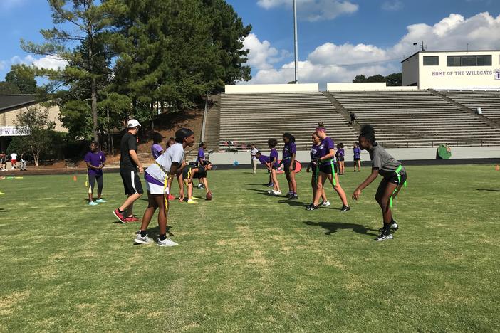 Duluth High School girls get set at the line of scrimmage before running a play in practice. 