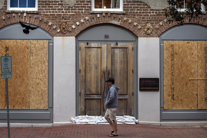 A pedestrian walks the nearly empty streets of historic downtown Savannah, Ga., Sunday, Sept., 10, 2017 before Hurricane Irma is forecast to impact the area.