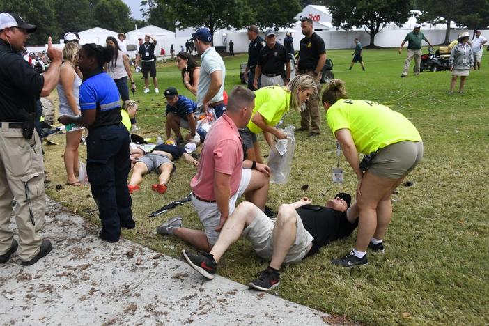 Spectators are tended to after a lightning strike on the course left several injured during a weather delay in the third round of the Tour Championship golf tournament Saturday, Aug. 24, 2019, in Atlanta. 