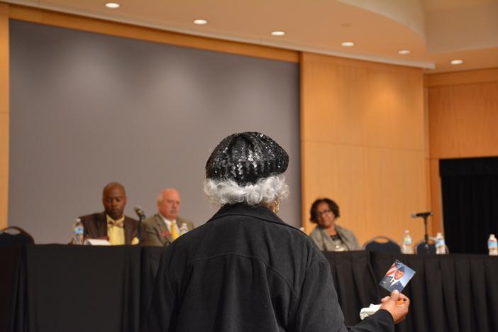 Bernice Smith telling members of the kinship care study committee about raising her grandson, Stephen, picture in hand.