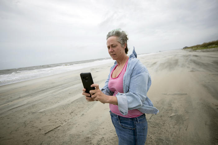 Crystal Travaille takes a cell phone photo of the wind and seas on the beach as Hurricane Dorian makes its way up the East Coast.