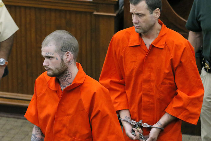 In this June 21, 2017, file photo, Ricky Dubose, left, and Donnie Russell Rowe enter the Putnam County courthouse in Eatonton, Ga.