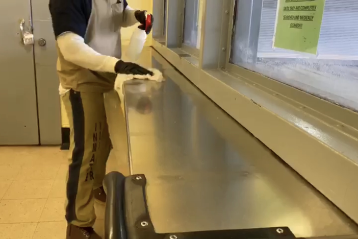 An inmate at Fulton County Jail cleans surfaces to avoid an outbreak of COVID-19.