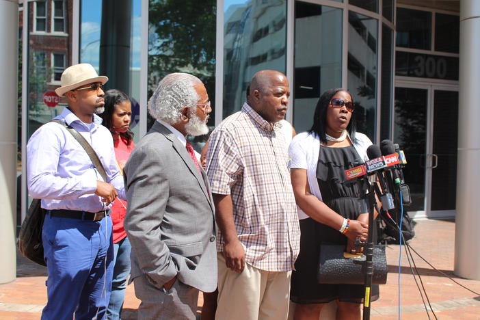 The family of Kendrick Johnson, the Valdosta teen found dead in a gym mat in his high school in 2013 outside the U.S. attorney's office in Macon Monday.