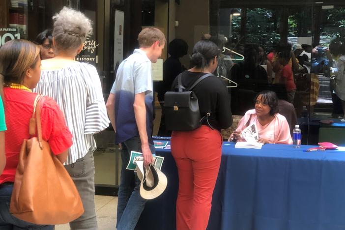 Author and genealogist Kenyatta Berry autographs books at Atlanta History Center for Juneteenth.