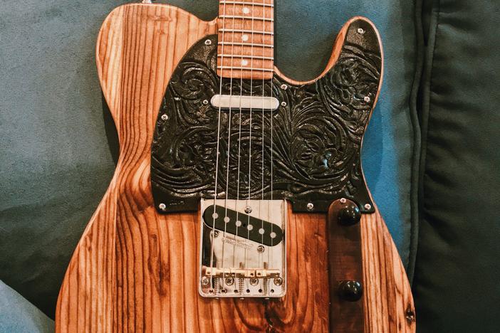 Atlanta musician Maggie Schneider's guitar is made from the wood of the Excelsior Mill in downtown Atlanta, former home of the Masquerade music venue.