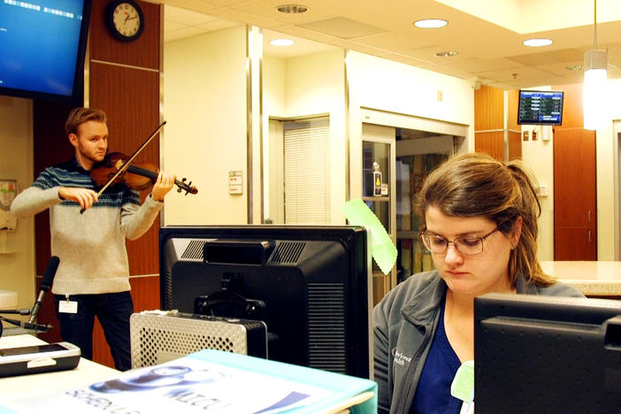 Violist Keoni Bolding performs in the Intensive Care Unit at Navicent Health in Macon recently.