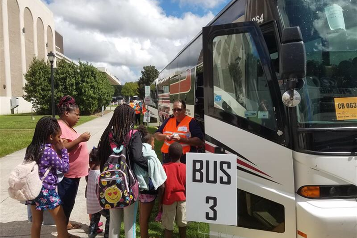 Evacuees board buses outside the Savannah Civic Center heading to Augusta.