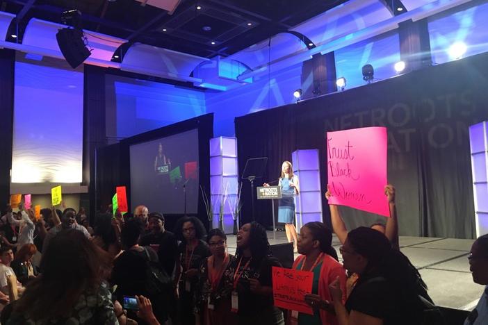 GA gubernatorial candidate Stacey Evans struggles to deliver a speech as protestors chant "Trust Black Women"