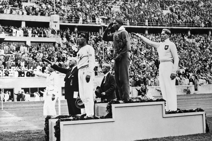 Jesse Owens on the podium after winning the long jump at the 1936 Summer Olympics in Berlin.