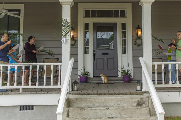 The Harpers, left, and the Lewises, right, sing Palm Sunday hymns together on the Lewis's Macon porch. 