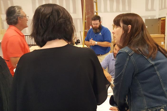 PIedmont Brewery and Kitchen co-owner Trish Whitley (in profile) in foreground. Husband and co-owner, Brian Whitley (beard and blue shirt) in background. 