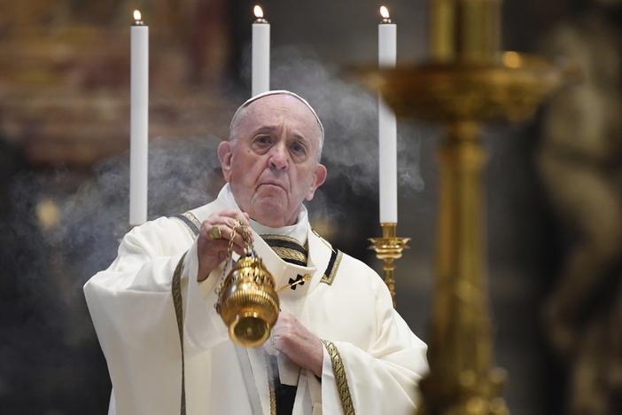 Pope Francis spreads incense at the start of Easter Sunday Mass, inside an empty St. Peter's Basilica at the Vatican, Sunday, April 12, 2020.